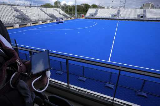 A cyber-security experts hold a tablet at the Yves du Manoir stadium, Friday, May 3, 2024 in Colomb…