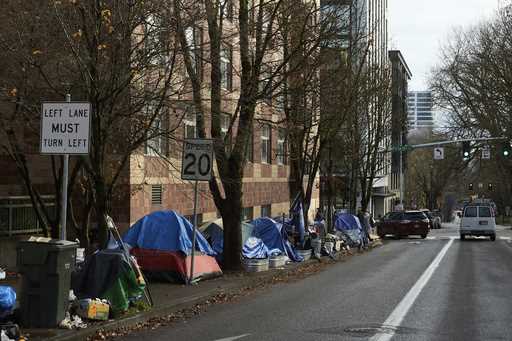 Tents line the sidewalk on SW Clay St in Portland, Ore