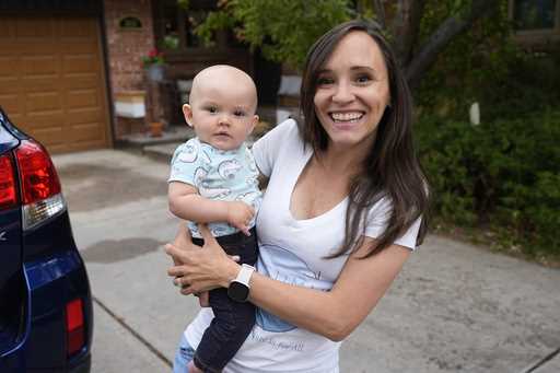 Carrie Martin-Haley holds her son outside their home Friday, May 10, 2024, in Greenwood Village, Co…