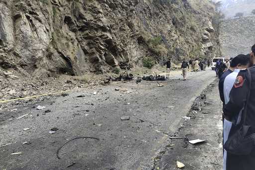 Police officers examine the site of suicide bombing at a highway in Shangla, a district in the Paki…