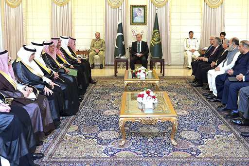 In this photo released by Prime Minister Office, visiting Saudi Foreign Minister Prince Faisal bin …