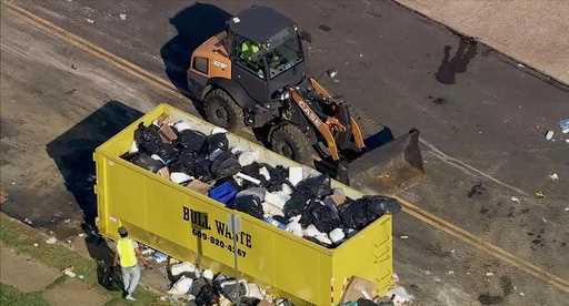 Trash is cleaned up at a drop-off site in Philadelphia as thousands of city workers remained on str…
