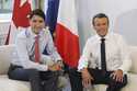 Canadian Prime Minister Justin Trudeau, left, poses with French President Emmanuel Macron during a …