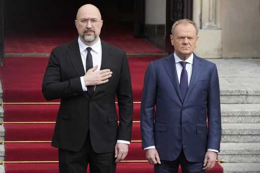 Ukrainian Prime Minister Denys Shmyhal, left, is escorted by his Polish counterpart, Donald Tusk, r…
