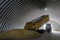 A dump track unloads grain in a granary in the village of Zghurivka, Ukraine, August 9, 2022