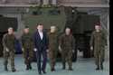 Poland's Defense Minister Mariusz Blaszczak, center, walks during ceremony after receiving its firs…