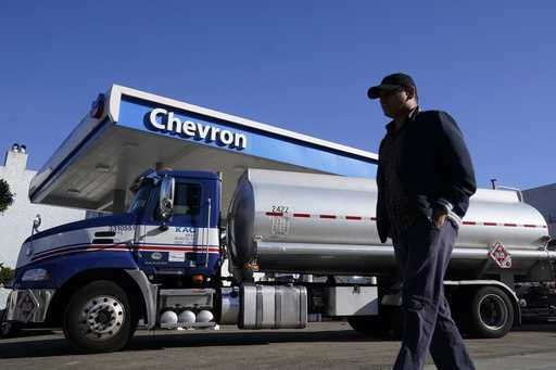A man walks past a tanker at a Chevron gas station in San Francisco, October 23, 2023