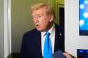 President Donald Trump speaks with reporters aboard Air Force One at Al Udeid Air Base in Doha, Qat…
