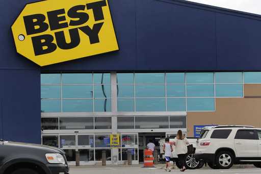A woman walks with a boy to the Best Buy store at the Mall of New Hampshire, Tuesday, August 4, 202…