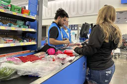 A customer checks out of a Walmart store Wednesday, February 21, 2024, in Englewood, Colo