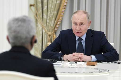Russian President Vladimir Putin speaks to India's Foreign Minister Subrahmanyam Jaishankar, back t…