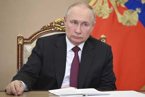 Russian President Vladimir Putin listens to Saratov region Governor Roman Busargin during their mee…
