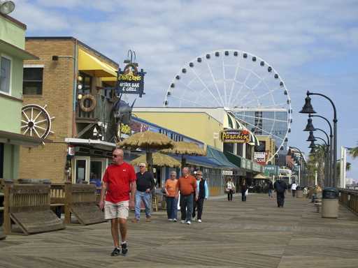 In this March 7, 2012 photo, visitors walk along the boardwalk in downtown Myrtle Beach, S