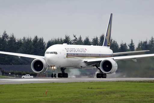 A Singapore Airlines Boeing 777-312ER readies to take off from Paine Field Tuesday, Sept