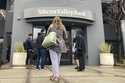 File - People stand outside of an entrance to Silicon Valley Bank in Santa Clara, Calif