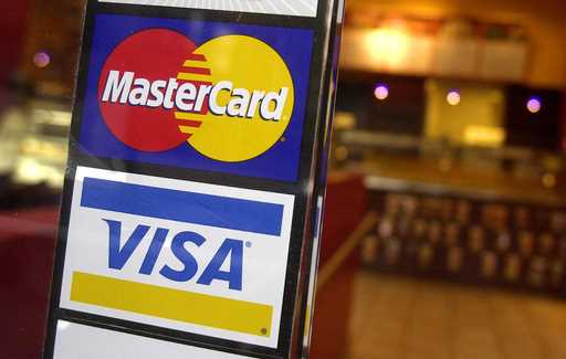 MasterCard and Visa credit card logos are shown at the entrance of a New York coffee shop, April 22…