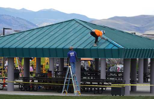 Workers paint the roof a picnic area in Clement Park April 17, 2024, in Littleton, Colo