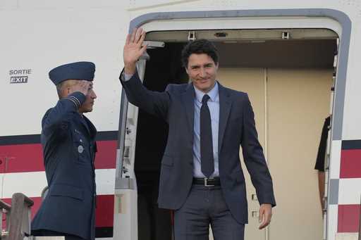 Canadian Prime Minister Justin Trudeau waves upon his arrival at the Seoul airport in Seongnam, Sou…