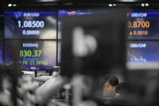 Currency traders work at the foreign exchange dealing room of the KEB Hana Bank headquarters in Seo…