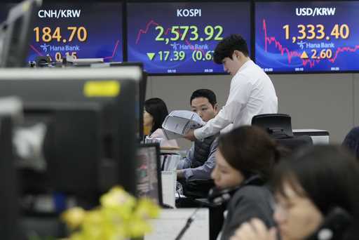 A currency trader watches monitors at the foreign exchange dealing room of the KEB Hana Bank headqu…