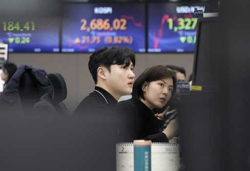 Currency traders watch monitors at the foreign exchange dealing room of the KEB Hana Bank headquart…