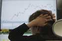 A dealer holds her hair at a dealing room of Hana Bank in Seoul, South Korea, Thursday, April 17, 2…