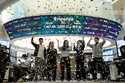 Currency traders celebrate as they work in the office with a screen showing the Korea Composite Sto…
