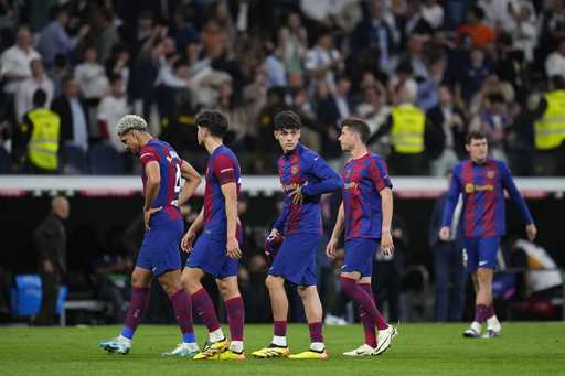 Barcelona players react as they leave the field at the end of the Spanish La Liga soccer match betw…