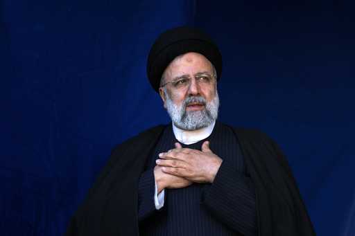 FILE- Iranian President Ebrahim Raisi places his hands on his heart as a gesture of respect to the …