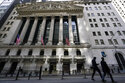 Pedestrians walk past the New York Stock Exchange in New York's Financial District, Tuesday, March …