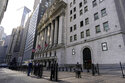A trader, right, talks to a pedestrian outside the New York Stock exchange, January 14, 2022, in th…