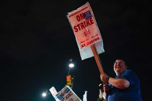 Machinist AJ Nelson, who has worked for Boeing for six years, works the picket line after union mem…