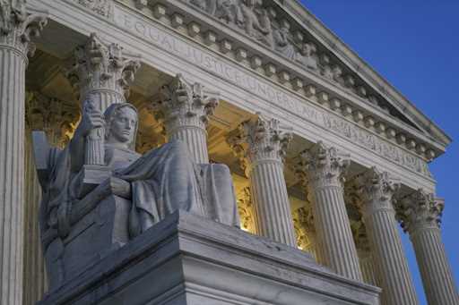 FILE- Light illuminates part of the Supreme Court building on Capitol Hill in Washington, November …