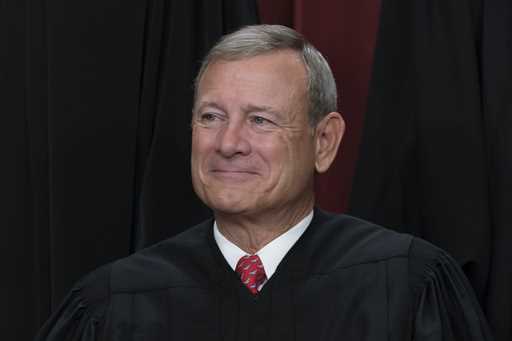 Chief Justice of the United States John Roberts joins other members of the Supreme Court as they po…