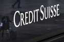 A woman walks past a logo of the Swiss bank Credit Suisse in Zurich, Switzerland, Friday, March 24,…