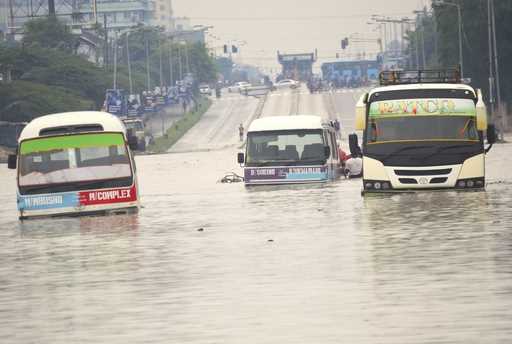 Public minibus are submerged in the flooded streets of Dar salaam, Tanzania Thursday, April 25, 202…