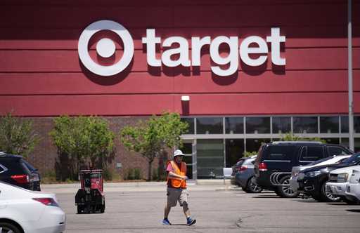 A worker collects shopping carts in the parking lot of a Target store on June 9, 2021, in Highlands…