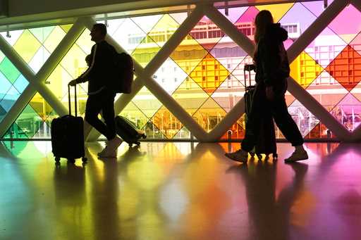 Travelers walk through Miami International Airport on November 22, 2023, in Miami