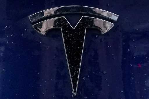 A Tesla electric vehicle emblem is affixed to a passenger vehicle Sunday, February 21, 2021, in Bos…