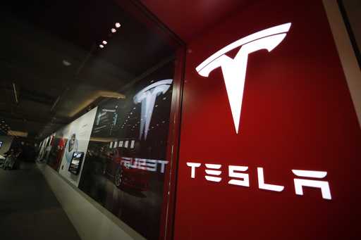 The Tesla logo is displayed at the company's store in Cherry Creek Mall, February 9, 2019, in Denve…