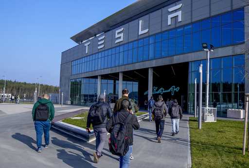 People walk to the Tesla Gigafactory for electric cars in Gruenheide near Berlin, Germany,March 13,…