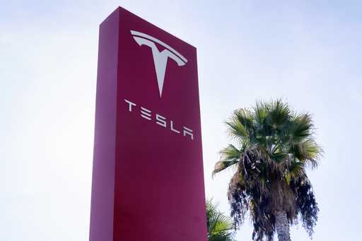 A Tesla sign is seen at a dealership, December 3, 2023, in Buena Park, Calif