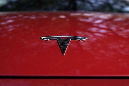 A Tesla logo is seen on a vehicle on display in Austin, Texas, February 22, 2023