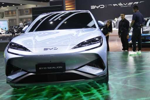 Visitors look at BYD's electric vehicle 