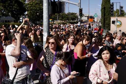 Fans wait to go through security before Taylor Swift performs at Levi's Stadium in Santa Clara, Cal…
