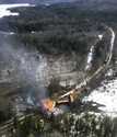 In this photo provided by the Maine Forest Service, several locomotives and rail cars burn after a …