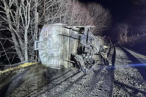 In this image provided by New York State Department of Environmental Conservation, train cars lie o…