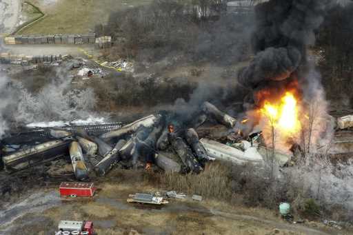 Portions of a Norfolk Southern freight train that derailed the night before burn in East Palestine,…