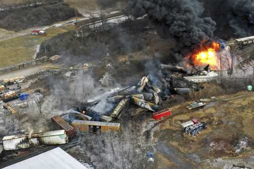 Debris from a Norfolk Southern freight train lies scattered and burning along the tracks on Februar…