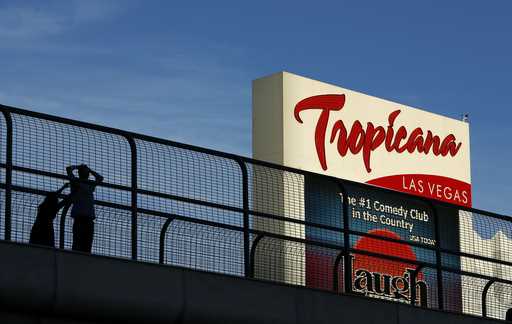 People stand on a pedestrian bridge by the Tropicana hotel and casino, August 4, 2015, in Las Vegas…